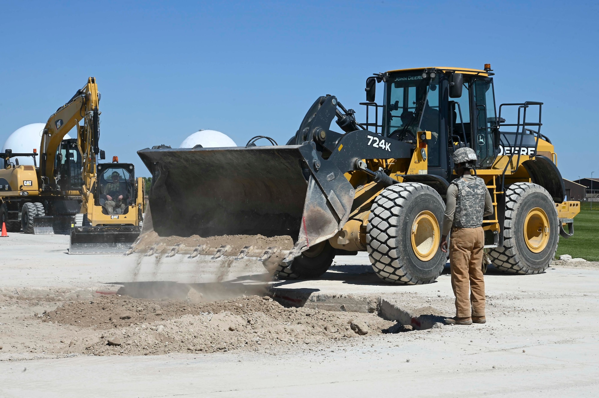 U.S. Airmen assigned to the 100th Civil Engineer Squadron fill a hole with dirt creating a foundation to build an operational flight line during combat readiness inspection Skyway Chariot at RAF Feltwell, England, May 9, 2025.
