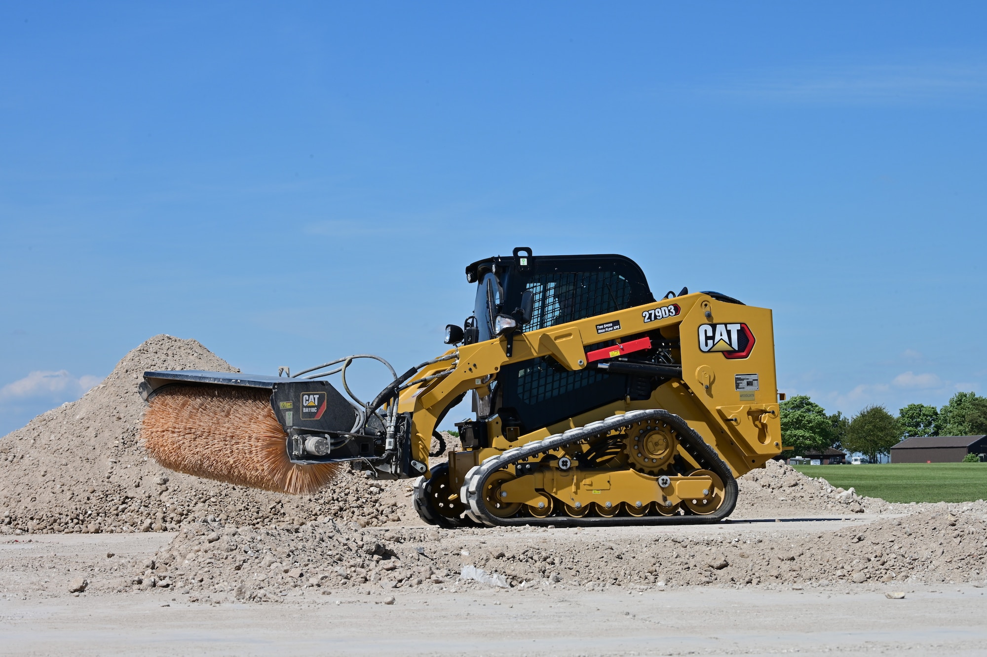 A U.S. Airman assigned to the 100th Civil Engineer Squadron drives a bobcat skid steer to clear the flight line of debris during combat readiness inspection Skyway Chariot at RAF Feltwell, England, May 9, 2025.