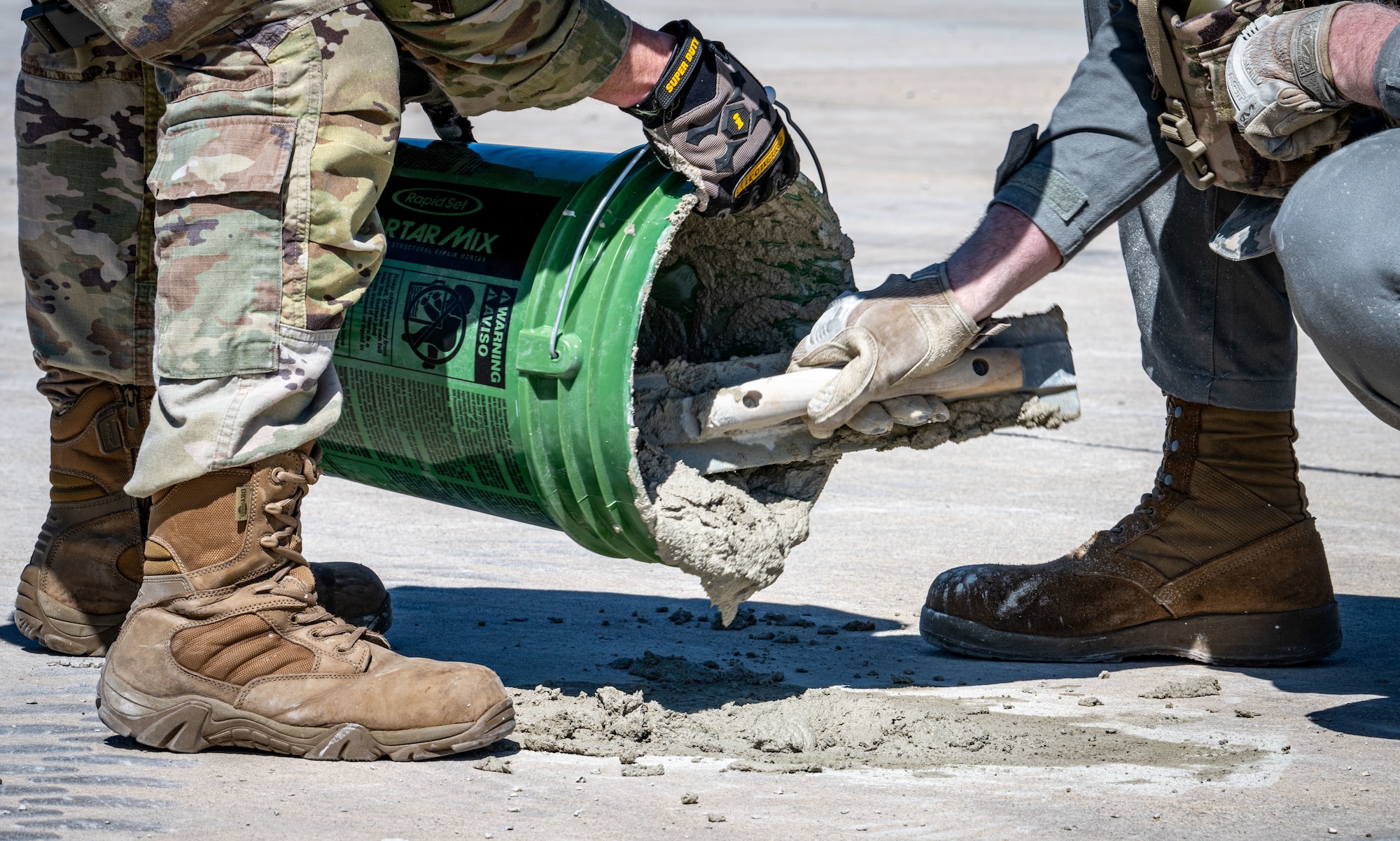 U.S. Airmen assigned to the 100th Civil Engineer Squadron use cement to make repairs to the damaged runway during combat readiness inspection Skyway Chariot at RAF Feltwell, England, May 9, 2025.