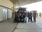 Class participants and instructors pose for a picture in the USNHO ambulance bay.