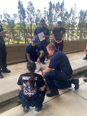 Instructors simulate a curb side pick up scenario that EMT's might encounter in situations like a vehicle accident.