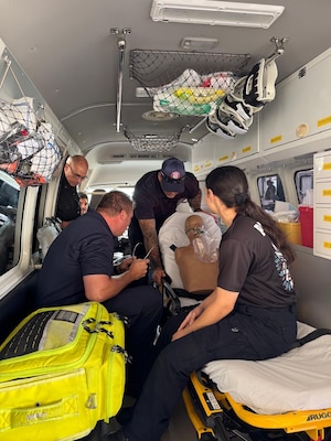Students observe a simulated scenario in the back of an ambulance.