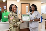 Jeanne Mitchell receiving DAISY Award from Col. Bowser