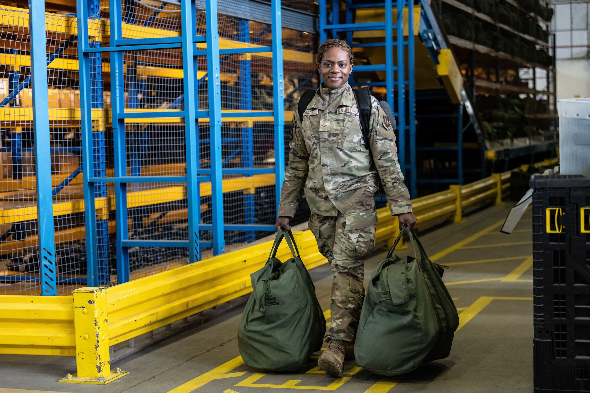 U.S. Air Force Airman 1st Class Maisha Rho, 100th Civil Engineer Squadron emergency management apprentice, carries her bags for a simulated deployment during combat readiness inspection Skyway Chariot at RAF Mildenhall, England, May 8, 2025.