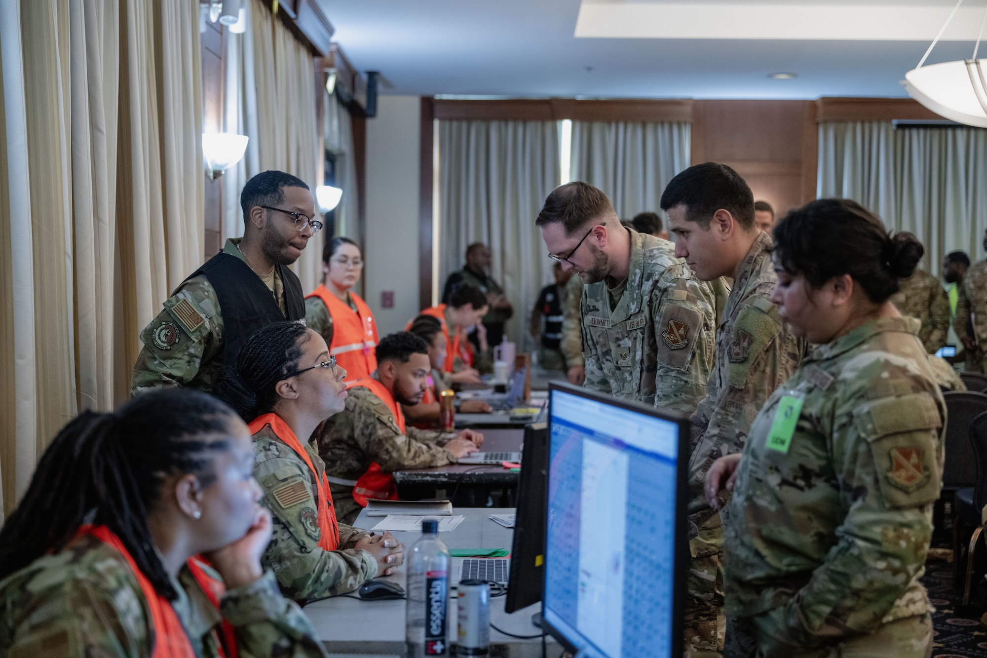 Airmen process through a simulated deployment function line during a Combat Readiness Inspection.