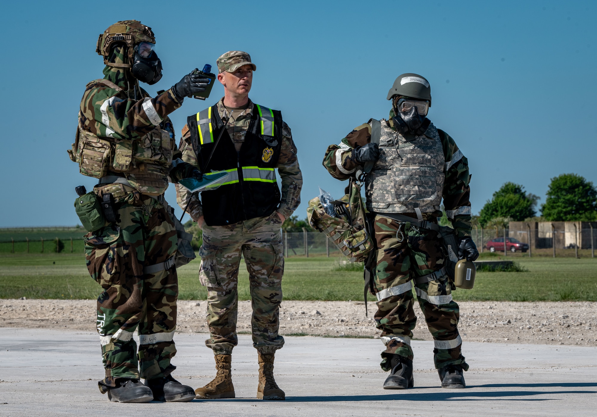 U.S. Airmen assigned to the 100th Civil Engineer Squadron explain to an inspector how they are inspecting the area for simulated hazardous materials during combat readiness inspection Skyway Chariot at RAF Feltwell, England, May 10, 2025.