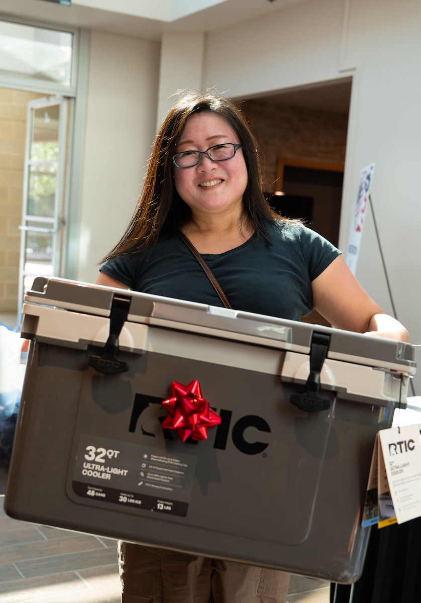 Biko Garcia, spouse, wins a cooler from the door prize event during the Spouse Resiliency & Wellness Day at the Powell Event Center, Goodfellow Air Force Base, Texas, May 9, 2025. All spouses were entered into drawings upon arriving at the event and were randomly selected to win door prizes. (U.S. Air Force photo by Airman 1st Class Brian Lummus)
