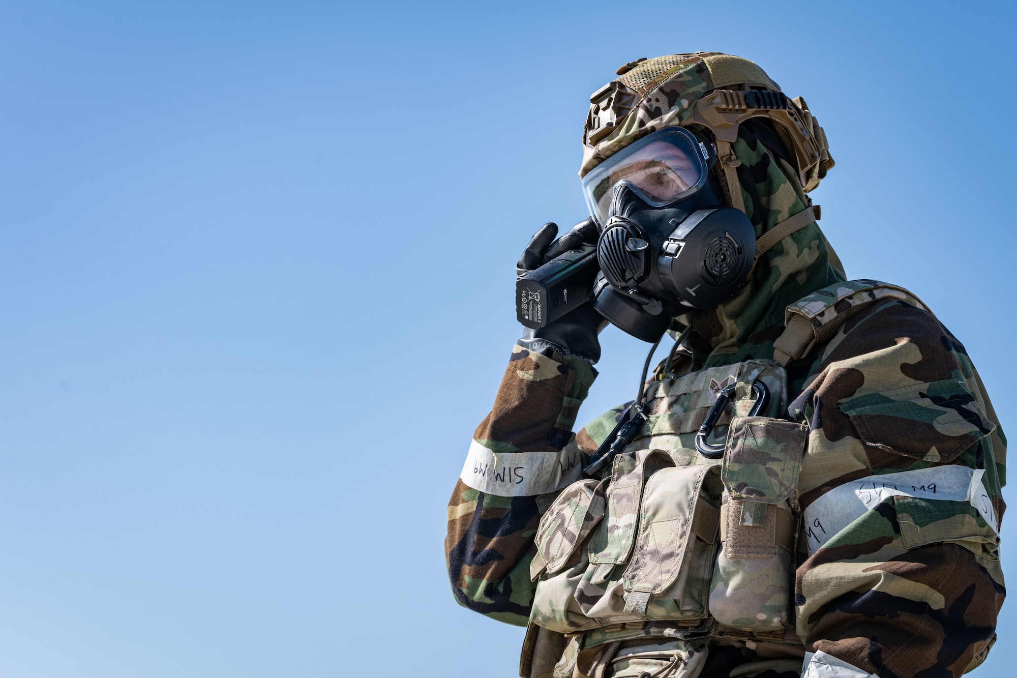 U.S. Air Force Senior Airman Justin Baker, 100th Civil Engineer Squadron emergency management journeyman, reports simulated hazardous material on a handheld radio during combat readiness inspection Skyway Chariot at RAF Feltwell, May 10, 2025.