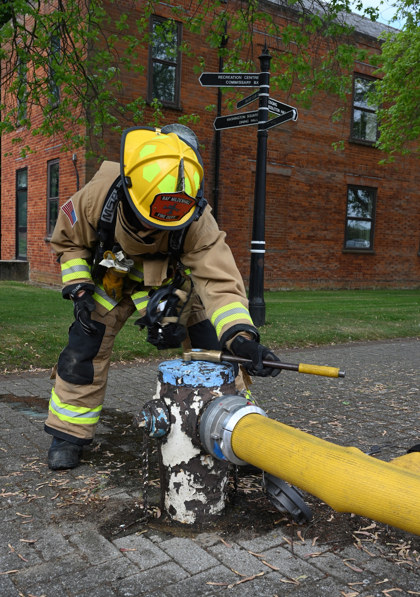 A U.S. Air Force firefighter assigned to the 100th Civil Engineer Squadron Fire Department turns off water flow from a hydrant after responding to a simulated vehicle-borne improvised explosive device scene during the combat readiness inspection Skyway Chariot at RAF Mildenhall, England, May 8, 2025.