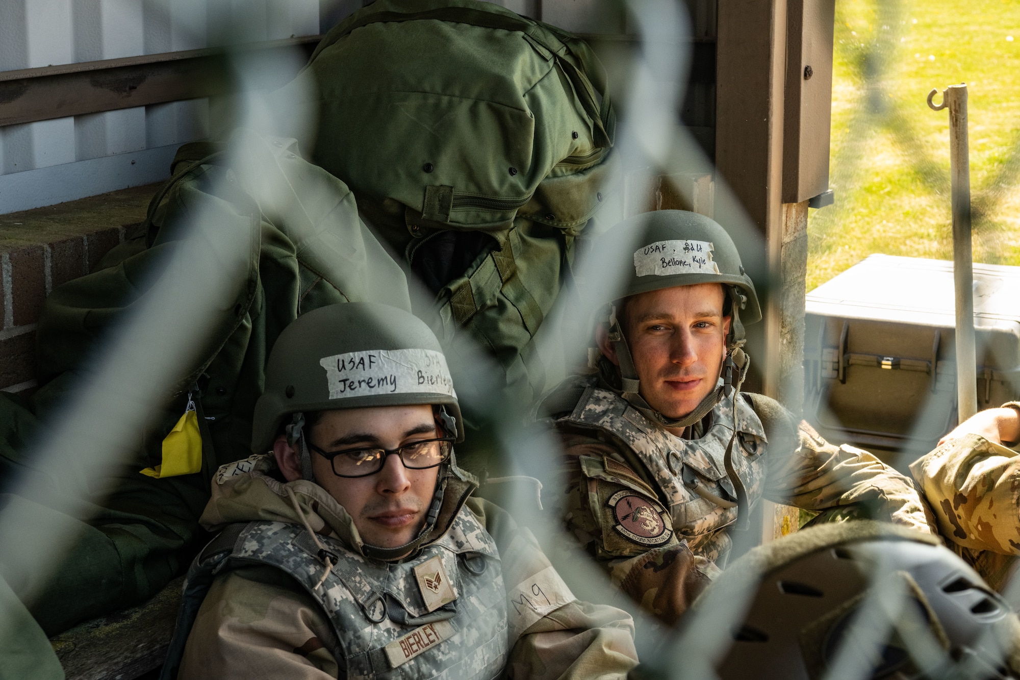 U.S. Air Force Senior Airman Jeremy Bierley, left, 100th Communication Squadron Agile Combat Employment technician, and 2nd Lt. Kyle Bellone, 100th CS Special Mission Flight officer in charge, simulate taking cover in a hardened shelter during combat readiness inspection Skyway Chariot at RAF Feltwell, May 10, 2025.