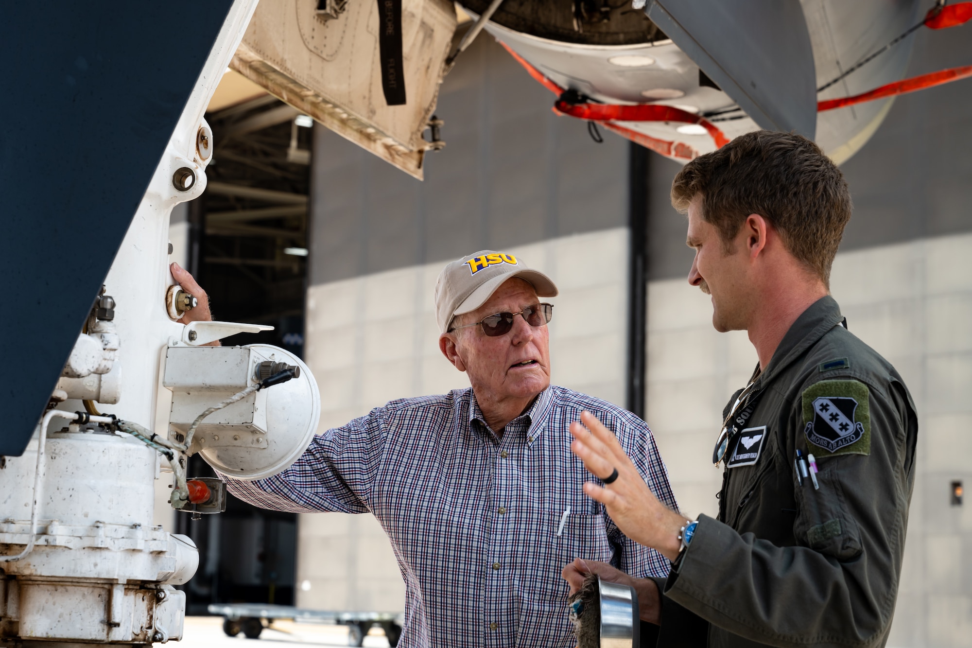 Larry Dyess, relative of Lt. Col. William E. Dyess, left, learns about the B-1B Lancer from 1st Lt. Colton Roach, 9th Bomb Squadron pilot, during a tour at Dyess Air Force Base, Texas, May 9, 2025. William E. Dyess, a U.S. Army Air Forces pilot during World War II, survived the Bataan Death March and died December 22, 1943. (U.S. Air Force photo by Airman 1st Class Jade M. Caldwell)