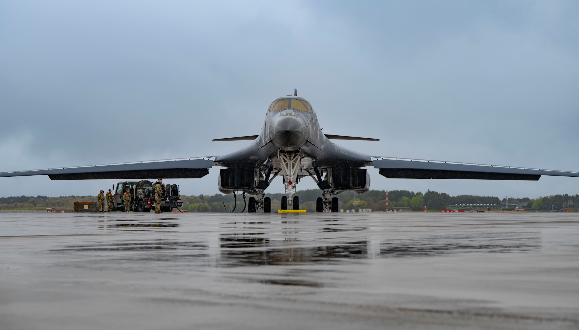 An airman performs maintenance on a B-1 bomber aircraft