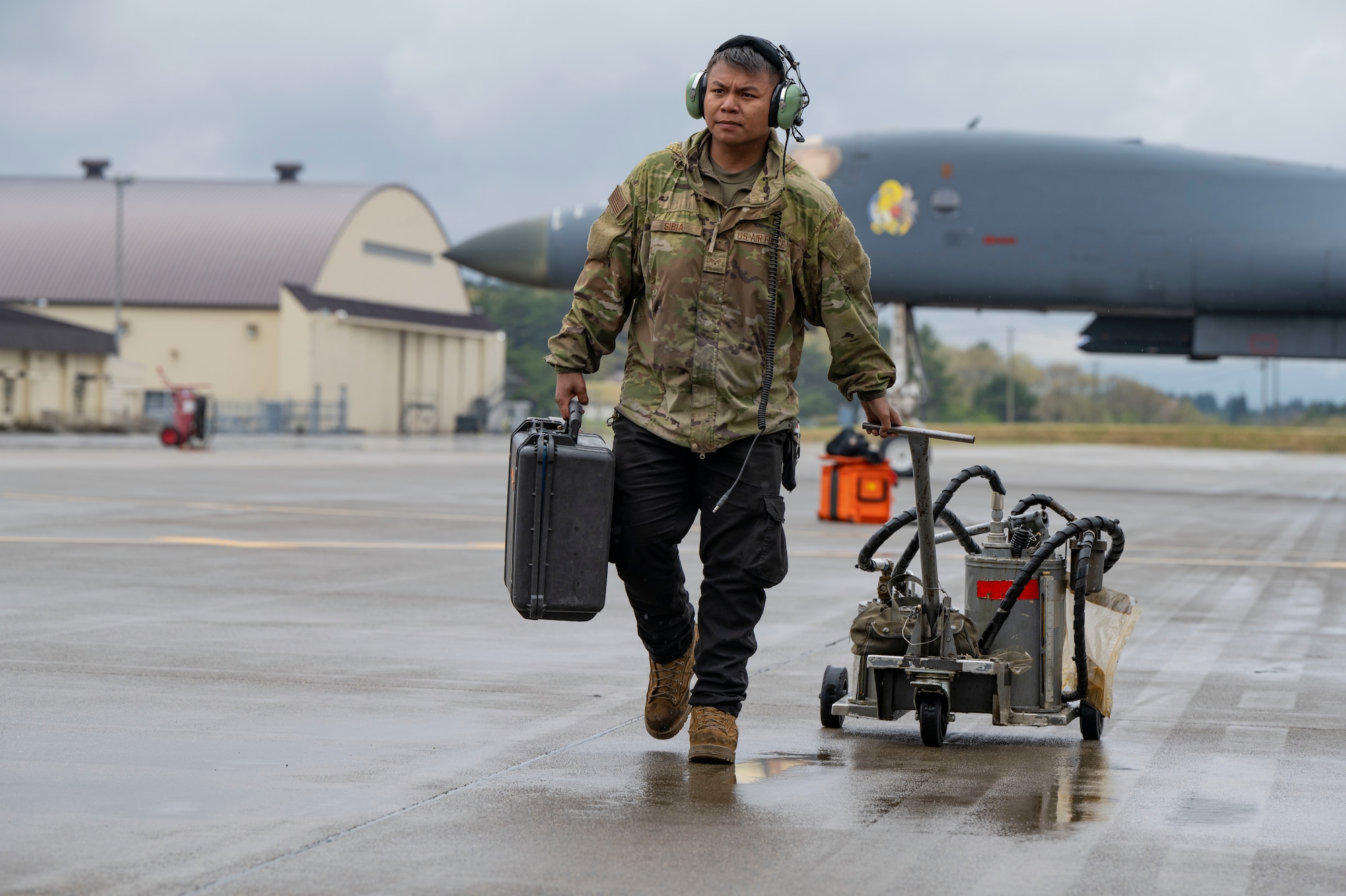 An airman performs maintenance on a B-1 bomber aircraft