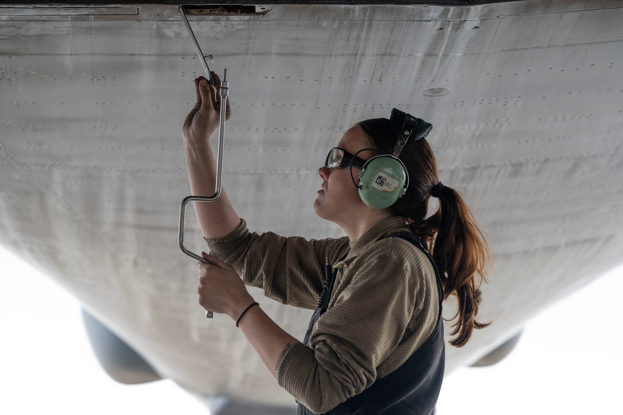 An airman performs maintenance on a B-1 bomber aircraft