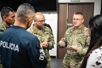 Master Sgt. Chris Wertz, Missouri National Guard State Partnership Program NCO, speaks to members of the Panamanian National Police as 2nd Lt. Minor Perez, a MONG chaplain candidate, translates in Panama City, Panama, May 8, 2025.