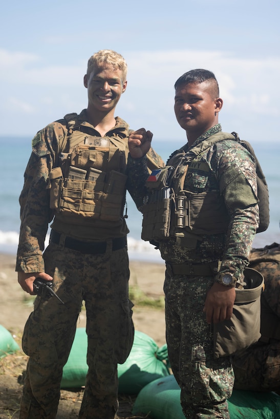U.S. Marine Corps Cpl. Adam Clyne, an assistant patrol leader with 2nd Battalion, 1st Marine Regiment, Marine Rotational Force – Darwin 25.3, and a Philippine Marine with 3rd Marine Brigade, Philippine Marine Corps, pose for a photo before a counter-landing live-fire rehearsal in support of Exercise Balikatan 25 at Rizal, Palawan, Philippines, April 27, 2025.