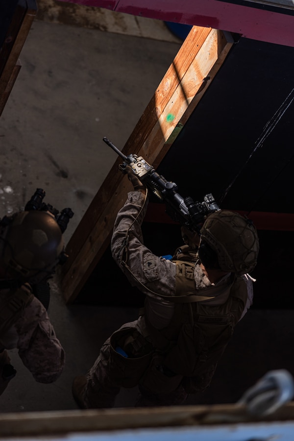 U.S. Marine Corps Cpl. Ezra Jackson, a team leader with Lima Company, 3rd Battalion, 1st Marine Regiment, 1st Marine Division, maneuvers into a doorway during a raid leaders course hosted by Expeditionary Operations Training Group, I Marine Expeditionary Force, at Marine Corps Base Camp Pendleton, California, April 23, 2025. EOTG is a section of the I MEF command element that trains and evaluates deploying Marine units in select individual and collective tasks to enhance their tactics, techniques, and procedures. Jackson is a native of Washington. (U.S. Marine Corps photo by Sgt. Atticus Martinez)