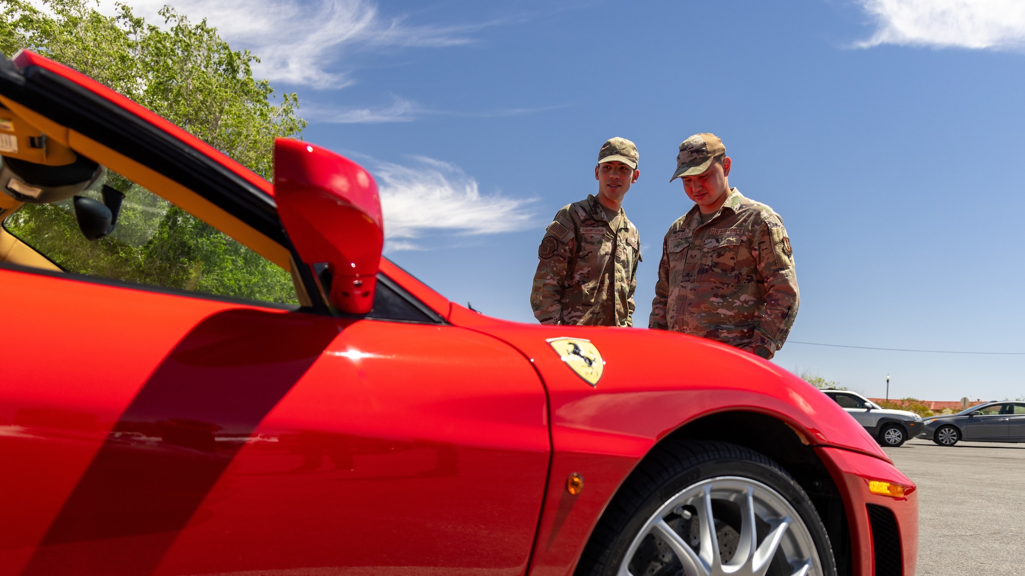 Airman 1st Class Tony Versammy Cepero, 412th Operations Support Squadron, and Staff Sgt. Angel Nolasco, 412th Logistics Support Squadron, examine Ferraris during a mini car show at Edwards Air Force Base, California, April 11. (Air Force photo by Blaine Torres)