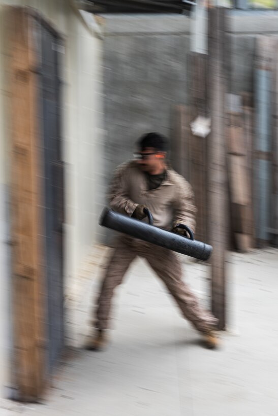 A U.S. Marine with India Company, 3rd Battalion, 1st Marine Regiment, 1st Marine Division, breaches a door during a raid leaders course hosted by Expeditionary Operations Training Group, I Marine Expeditionary Force, at Marine Corps Base Camp Pendleton, California, April 24, 2025.