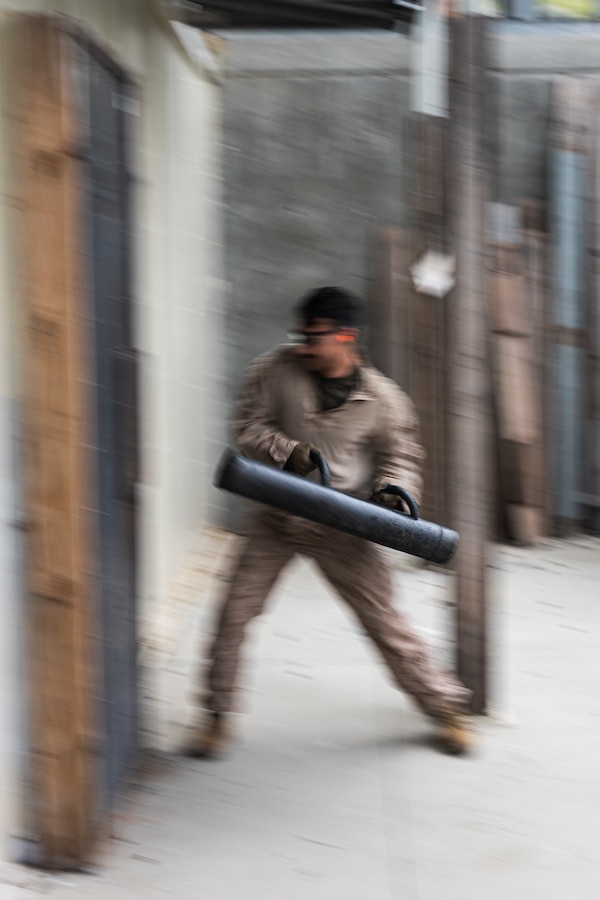 A U.S. Marine with India Company, 3rd Battalion, 1st Marine Regiment, 1st Marine Division, breaches a door during a raid leaders course hosted by Expeditionary Operations Training Group, I Marine Expeditionary Force, at Marine Corps Base Camp Pendleton, California, April 24, 2025. EOTG is a section of the I MEF command element that trains and evaluates deploying Marine units in select individual and collective tasks to enhance their tactics, techniques, and procedures. (U.S. Marine Corps photo by Sgt. Atticus Martinez)