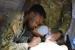 Army and Navy students in the Medical Education and Training Campus Respiratory Therapist course conduct a Joint Field Training Exercise on Joint Base San Antonio-Camp Bullis, Texas. Army Spc. Cheick Nana starts a needle chest decompression for a simulated patient with a tension pneumothorax.
