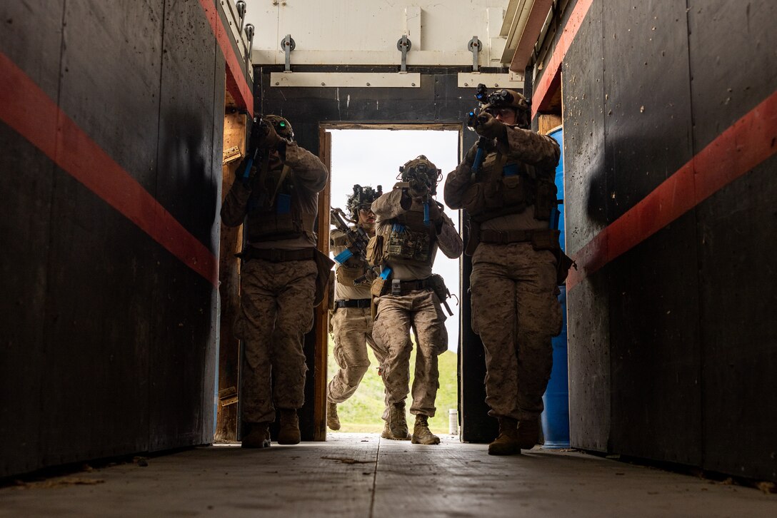 U.S. Marines with Lima Company, 3rd Battalion, 1st Marine Regiment, 1st Marine Division, clear a hallway during a raid leaders course hosted by Expeditionary Operations Training Group, I Marine Expeditionary Force, at Marine Corps Base Camp Pendleton, California, April 25, 2025.