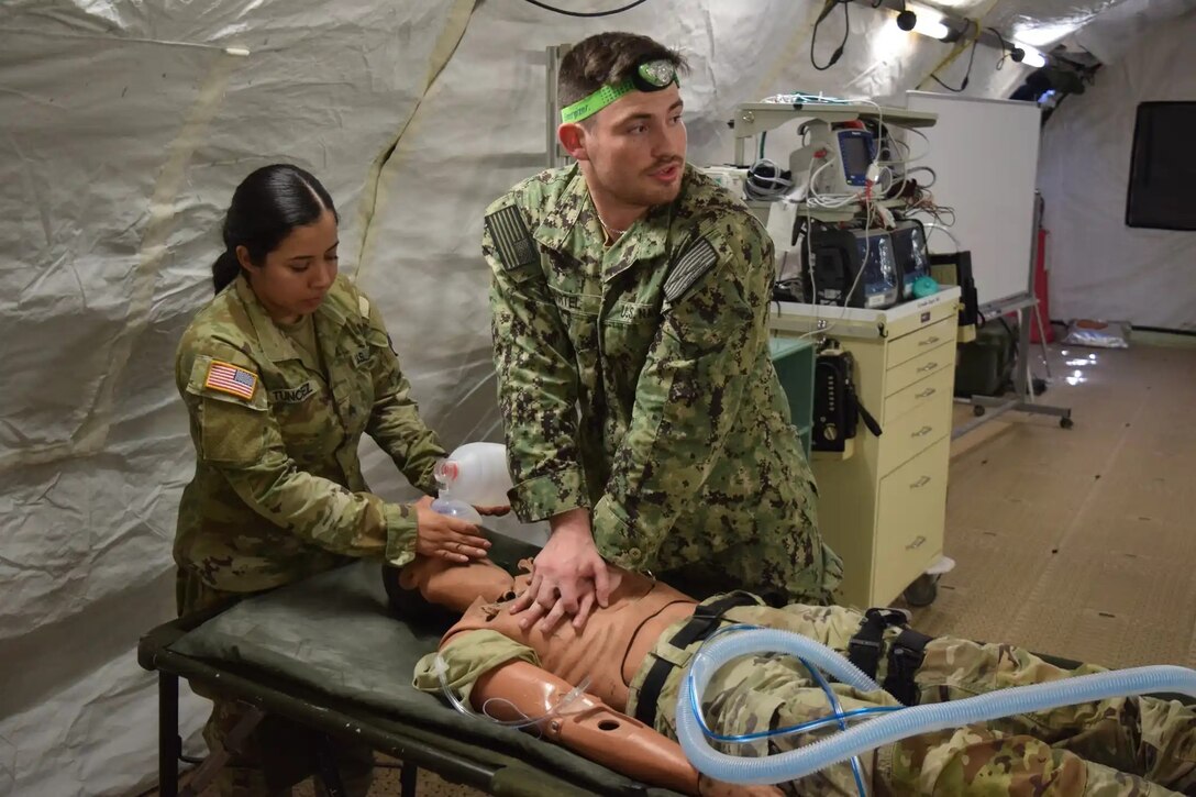 Army and Navy students in the Medical Education and Training Campus Respiratory Therapist course conduct a Joint Field Training Exercise on Joint Base San Antonio-Camp Bullis, Texas. During the JTFX, Army Sgt. Jaquelyn Tunchez and Navy Hospital Corpsman Benjamin Wirtel conduct cardiopulmonary resuscitation, or CPR, on a simulated patient.