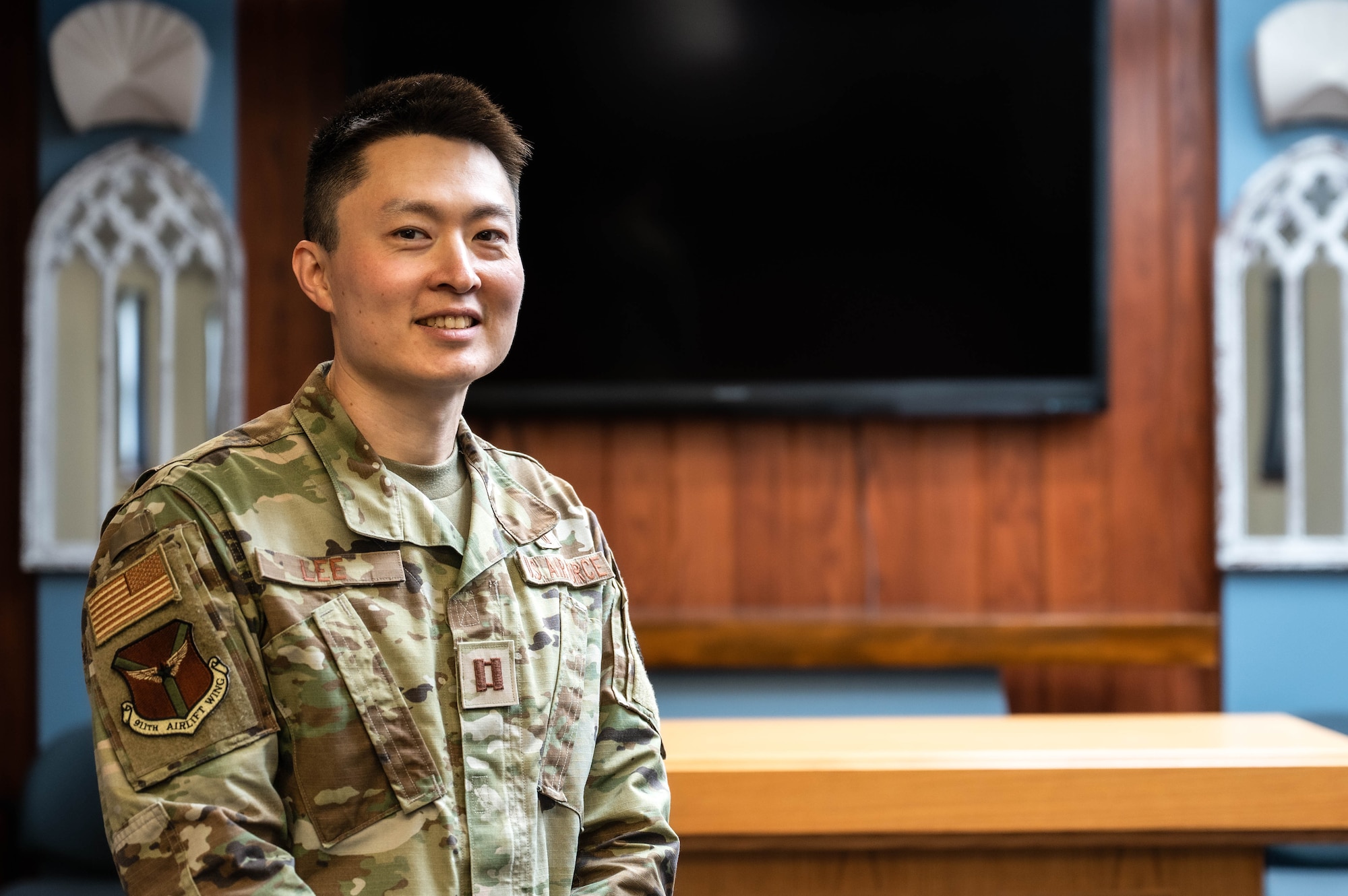 an Asian American Man wears a military uniform in a chapel.