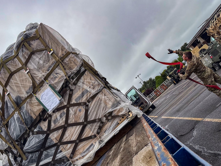 Man throws cargo strap