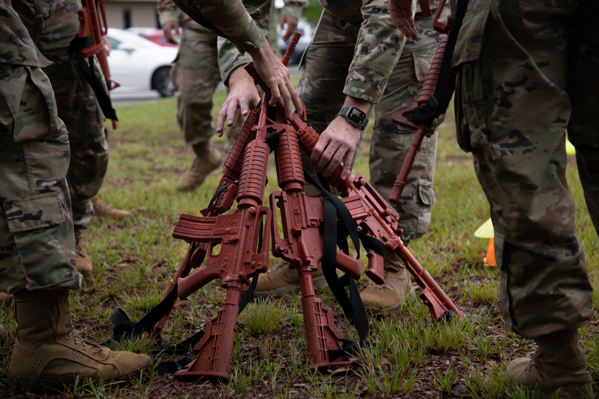 Airmen grabbing rubber rifles