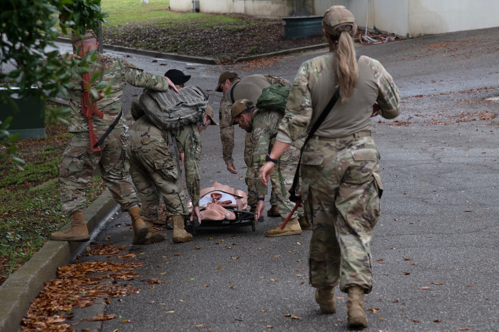 Airmen working with a litter