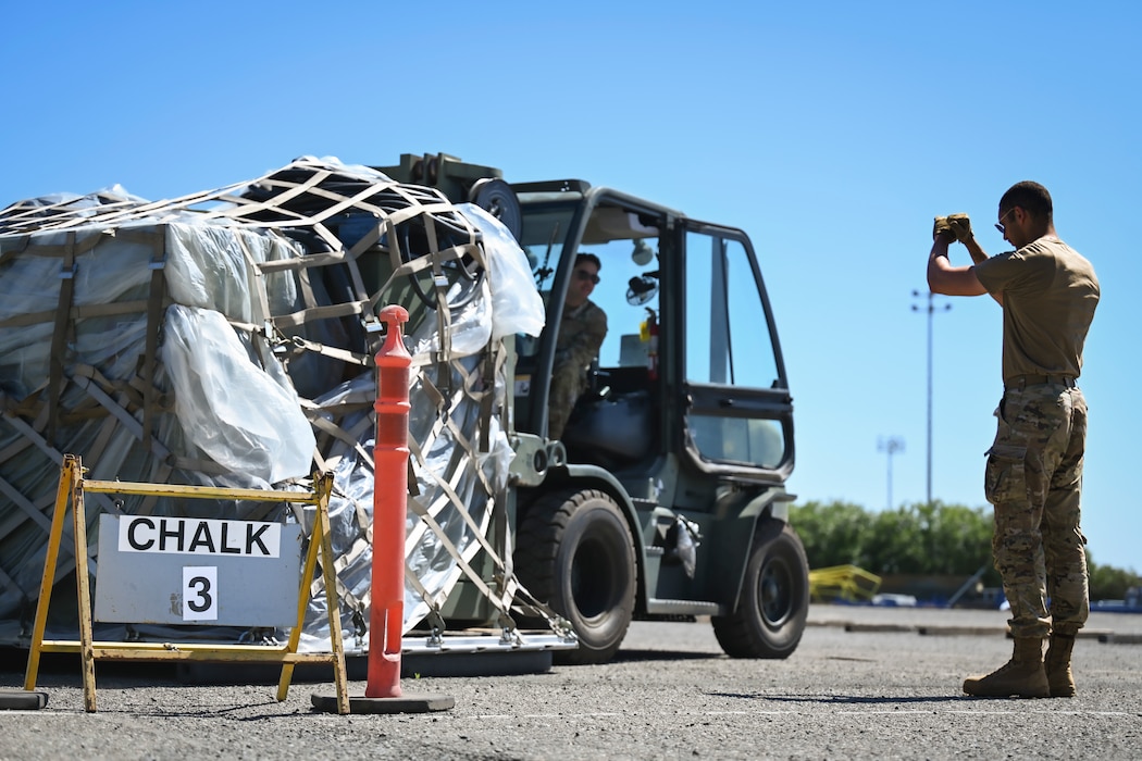 Men work together to move cargo