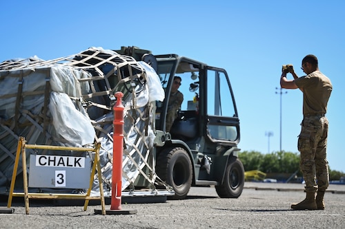 Men work together to move cargo