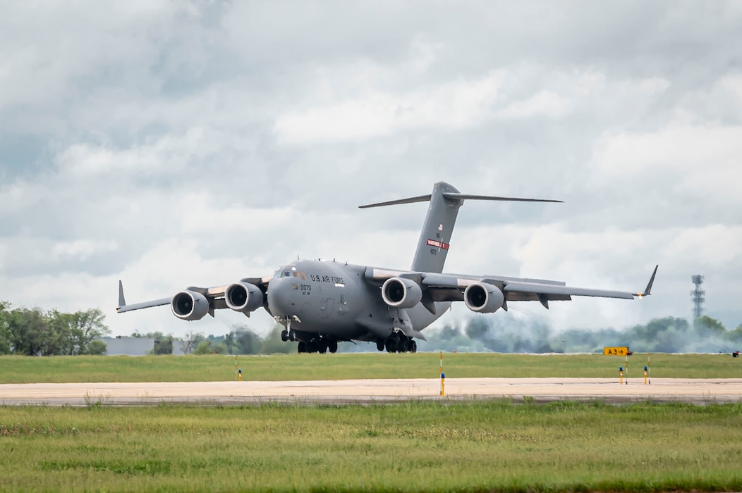 an aircraft touches down on a runway