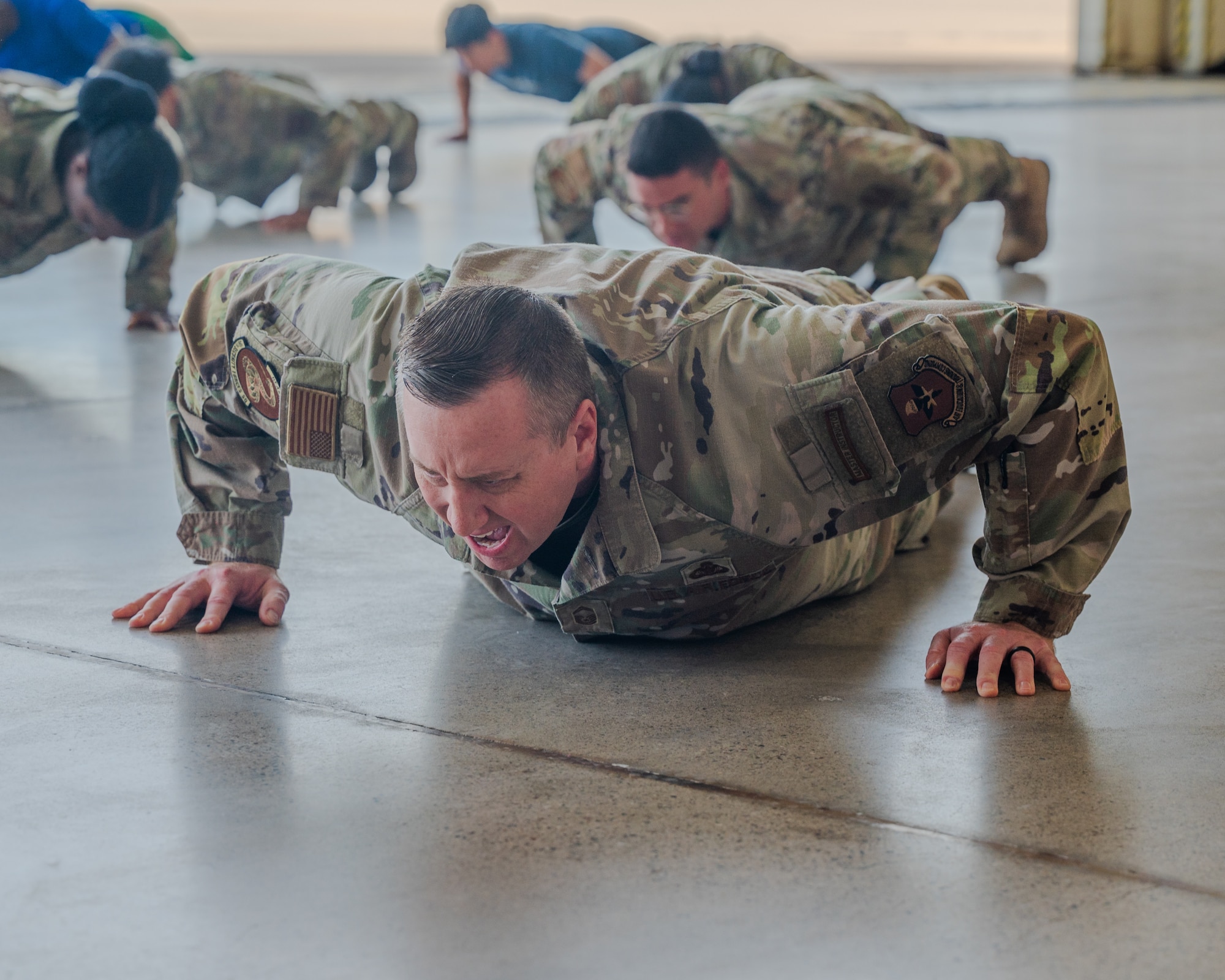 The 14 push-ups were performed by attendees of the opening ceremony to honor the “14 Fallen Defenders.” The “14 Fallen Defenders” serves as a reminder of the ultimate sacrifice made by 14 U.S. Air Force Security Forces members who have perished in action since the 9/11 attacks. (U.S. Air Force photo by Senior Airman Elias Carrero)