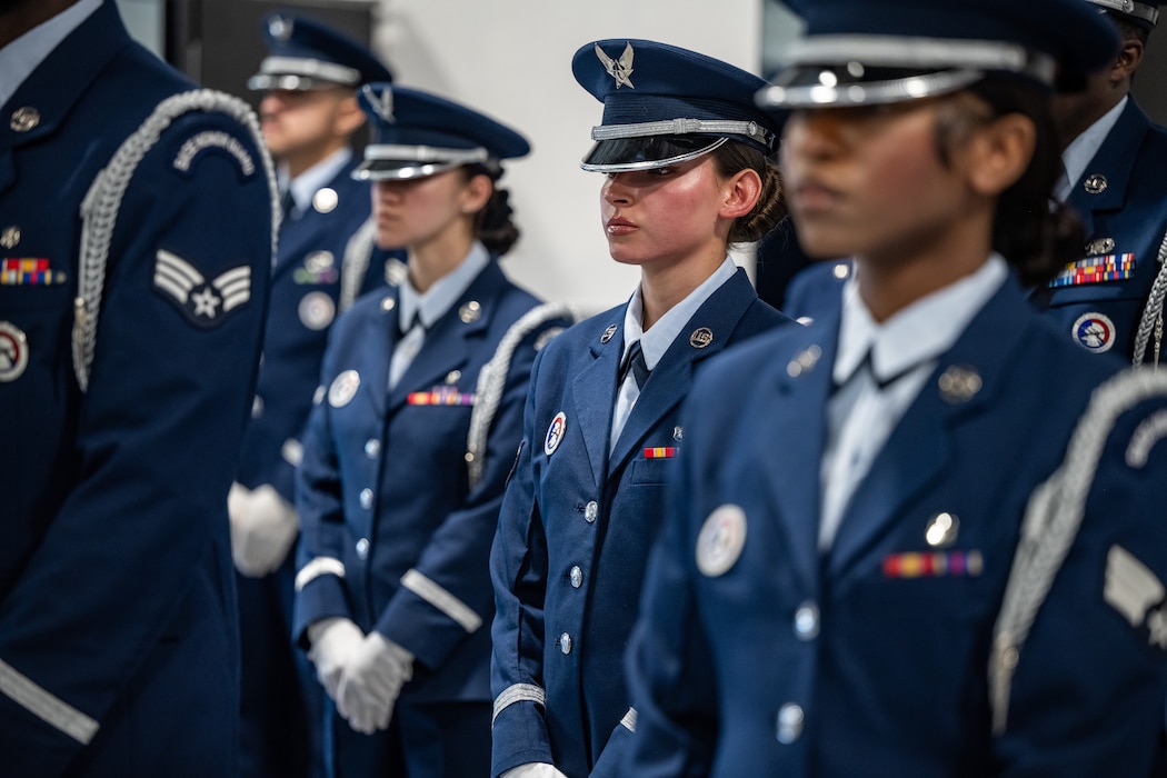 Honor guard members standing in formation wearing military service dress uniforms