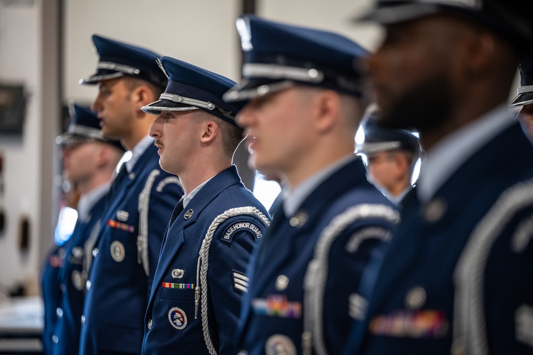 Side profile shot of several honor guard member in military service dress uniform