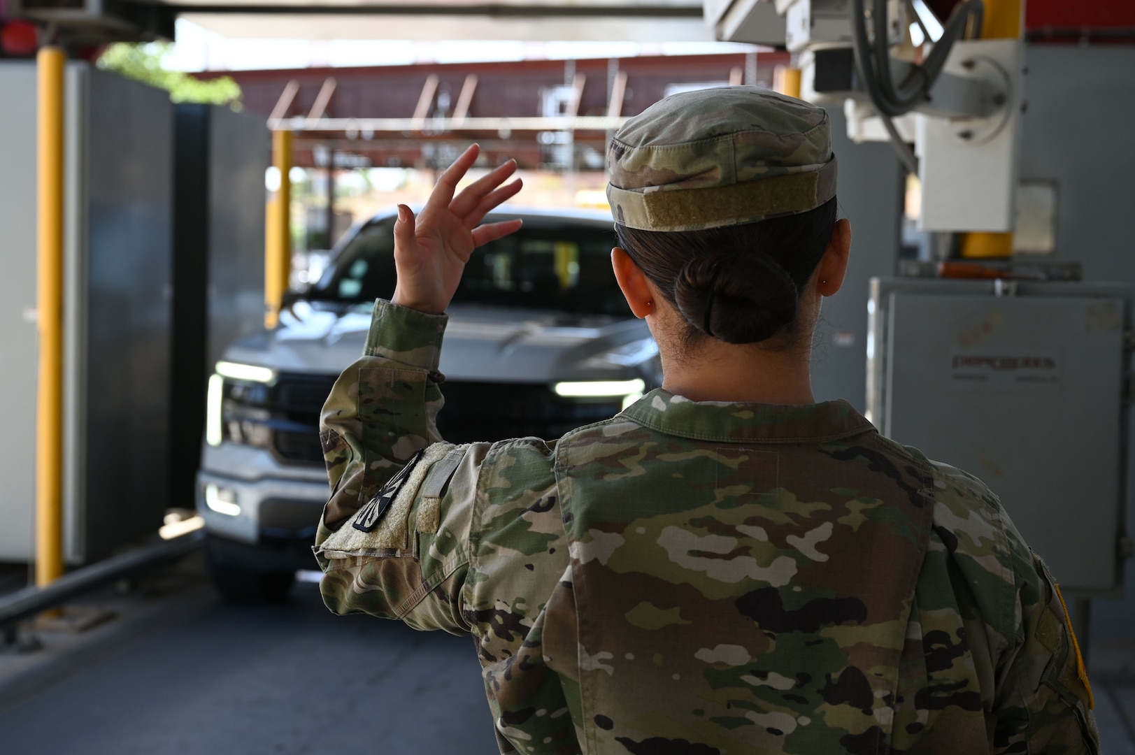 A U.S. Soldier with the Arizona Army National Guard signals for a vehicle to pass through the X-ray machine at the Mariposa Port of Entry in Nogales, Arizona, April 29, 2025.