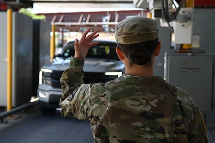 A U.S. Soldier with the Arizona Army National Guard signals for a vehicle to pass through the X-ray machine at the Mariposa Port of Entry in Nogales, Arizona, April 29, 2025.