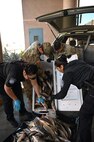 U.S. Soldiers with the Arizona Army National Guard and U.S. Customs and Border Protection agents inspect a cooler of fish for illegal drugs or other contraband items at the Dennis DeConcini Port of Entry in Nogales, Arizona, April 30, 2025.