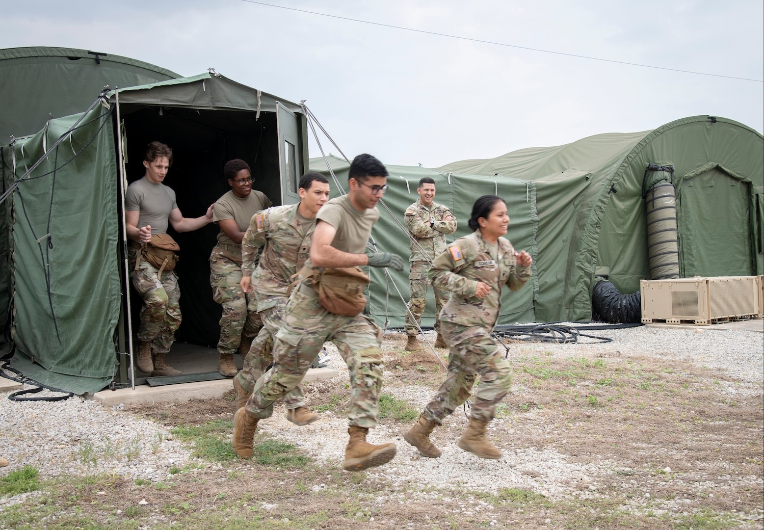 Practical Nursing students rush to respond to a simulated mass casualty event during a field training exercise at Joint Base San Antonio – Camp Bullis, Texas, April 25, 2025. The FTX, hosted by BAMC’s Department of Hospital Education and Training, was held at Camp Bullis’s Deployable Medical Systems Equipment Training site, which recreates genuine deployment conditions, complete with the exact equipment, layout, and operational constraints students will likely encounter in real-world missions. (DoD photo by Jason W. Edwards)