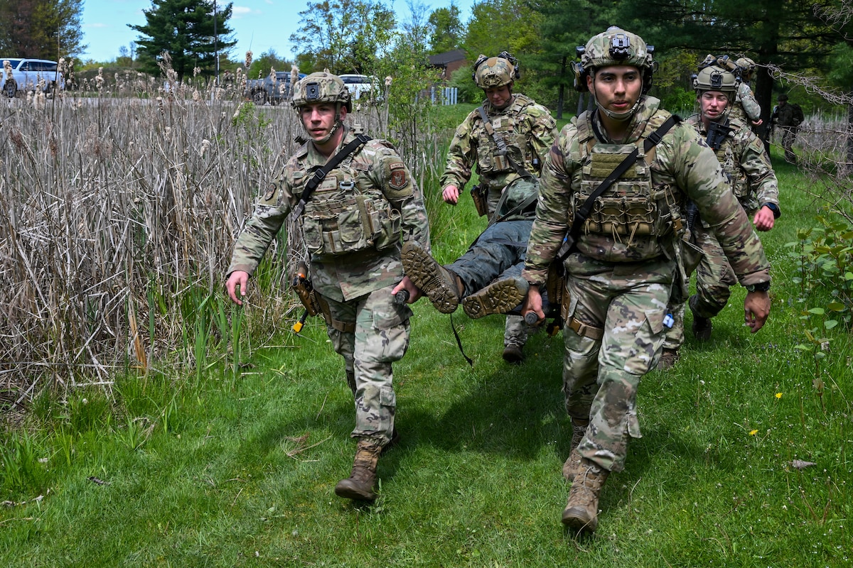 Members of the 446th Security Forces Squadron at Joint Base Lewis-McChord, Washington, and the 927th Security Forces Squadron at MacDill Air Force Base, Florida, carry a simulated victim to safety during tactical casualty combat care exercise as part of the Integrated Defense Leadership Course, May 9, at Youngstown Air Reserve Station, Ohio.