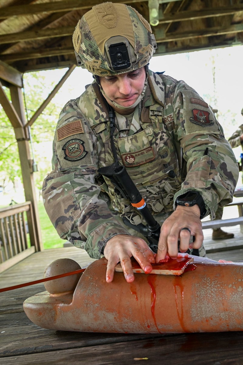 Tech. Sgt. Devin Britton, a member of the 446th Security Forces Squadron at Joint Base Lewis-McChord, Washington, packs a simulated wound during tactical casualty combat care training as part of the Integrated Defense Leadership Course, May 9, at Youngstown Air Reserve Station, Ohio.