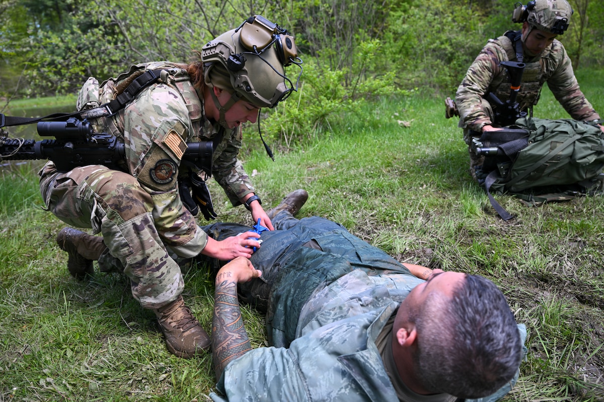Staff Sgt. Kristen Wurtz, a member of the 446th Security Forces Squadron at Joint Base Lewis-McChord, Washington, applies a tourniquet to a simulated victim during a tactical casualty combat care exercise as part of the Integrated Defense Leadership Course, May 9, at Youngstown Air Reserve Station, Ohio.