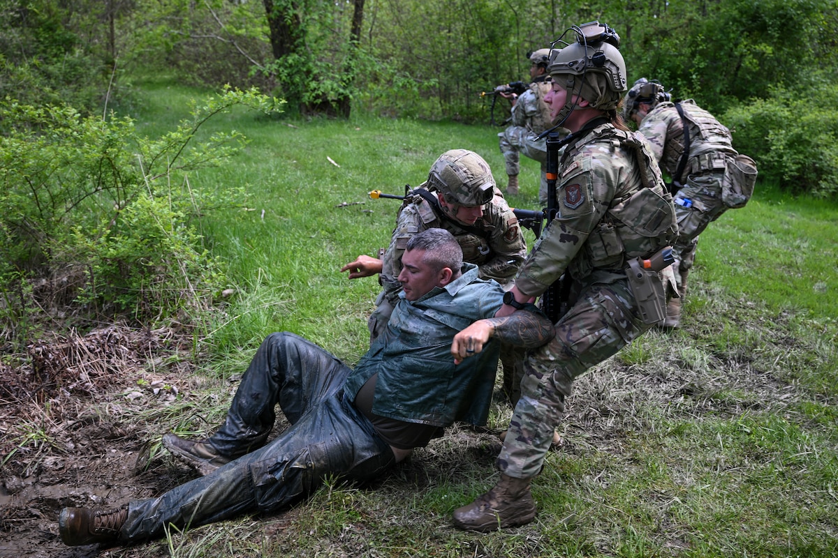 Staff Sgt. Dylan Jess and Staff Sgt. Kristen Wurtz, both members of the 446th Security Forces Squadron at Joint Base Lewis-McChord, Washington, pull a simulated victim from a pond during tactical casualty combat care exercise as part of the Integrated Defense Leadership Course, May 9, at Youngstown Air Reserve Station, Ohio.