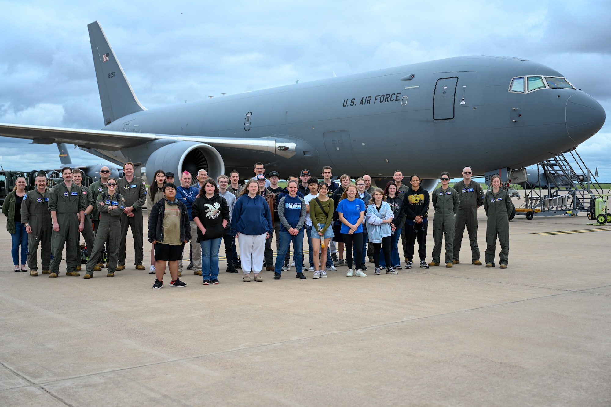 U.S. Air Force Airmen from the 97th Operations Group take a group photo with Enid High School Air Force Junior ROTC (AFJROTC) students in front of a KC-46 Pegasus aircraft at Altus Air Force Base, Okla. on April 30, 2025. AFJROTC is a high school elective with an Air Force structure that combines military organization with classroom instruction, hands-on leadership training, and responsibilities. (U.S. Air Force photo by Airman 1st Class Nathan Langston)
