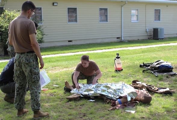 Hospital Corpsman Second Class (HM2) Brianna Connaghan assesses a mannequin for injury during a Tactical Combat Casualty Care (TCCC) Course at Navy Medicine Readiness and Training Command (NMRTC) Patuxent River. TCCC is a pre-hospital trauma care system specifically designed for the tactical environment.  The program emphasized rapid assessment and treatment of life-threatening injuries under stress, while minimizing the risk to the rescuer. NMRTC Patuxent River offers the TCCC course monthly, ensuring sailors maintain their qualifications.