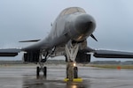 A B-1 bomber sits on the flightline in the rain