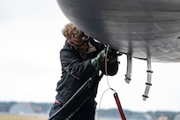 A B-1 bomber sits on the flightline in the rain