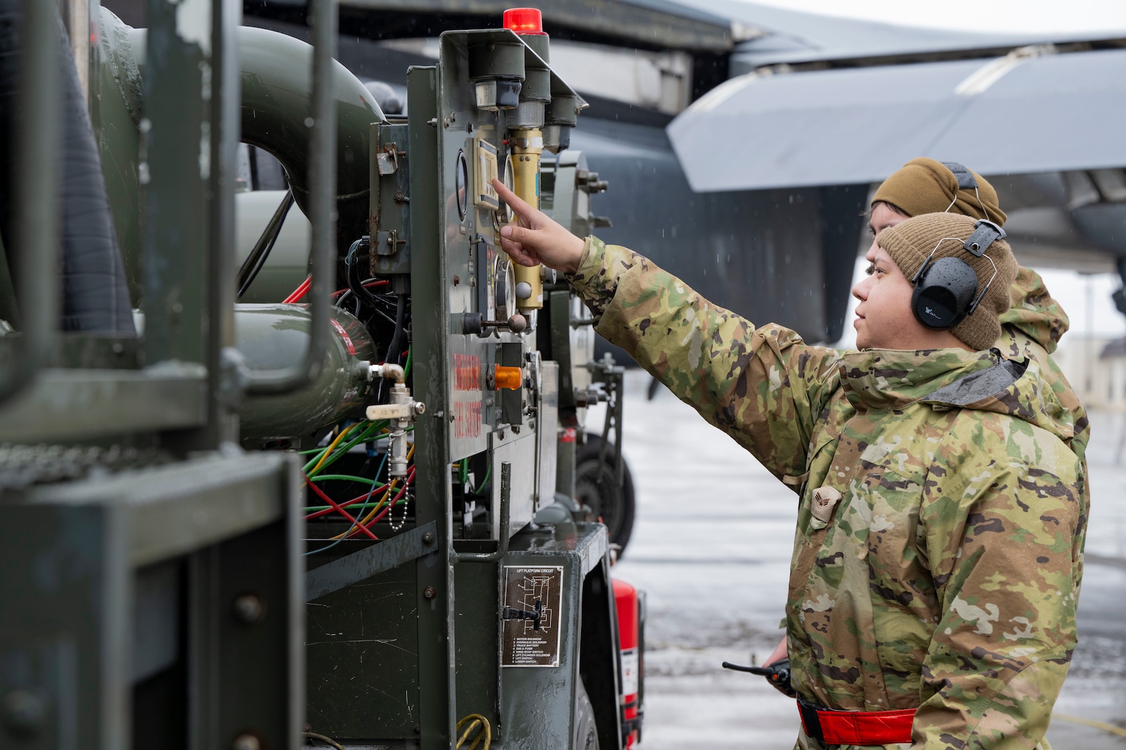 An airman performs maintenance on a B-1 bomber aircraft
